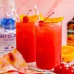 Close up square image of finished cocktails garnished.