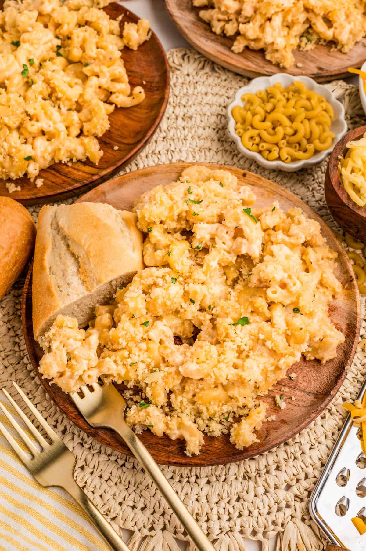 Smoked Mac and Cheese on wooden plate with a slice of bread.