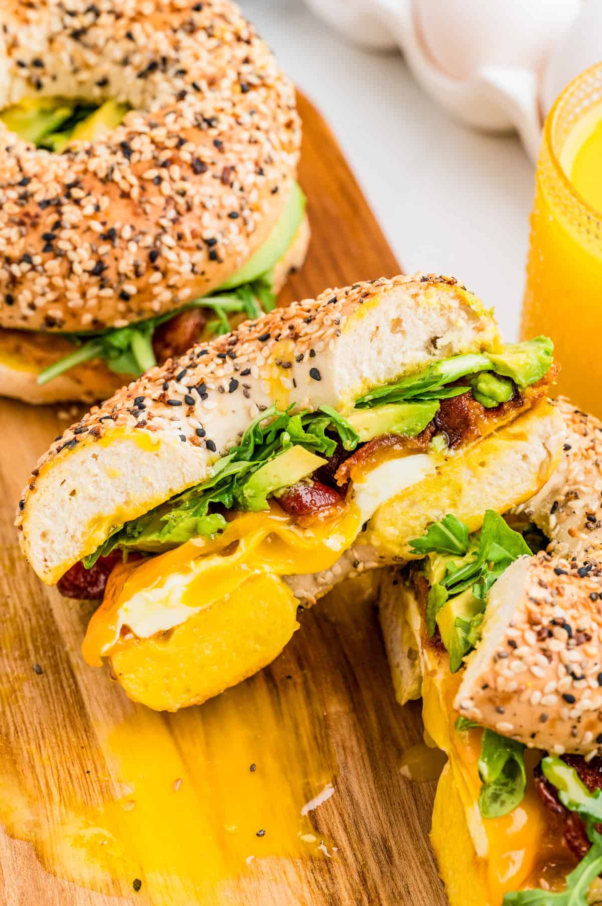 Stacked half of sandwich on another showing layers of sandwich and runny egg.