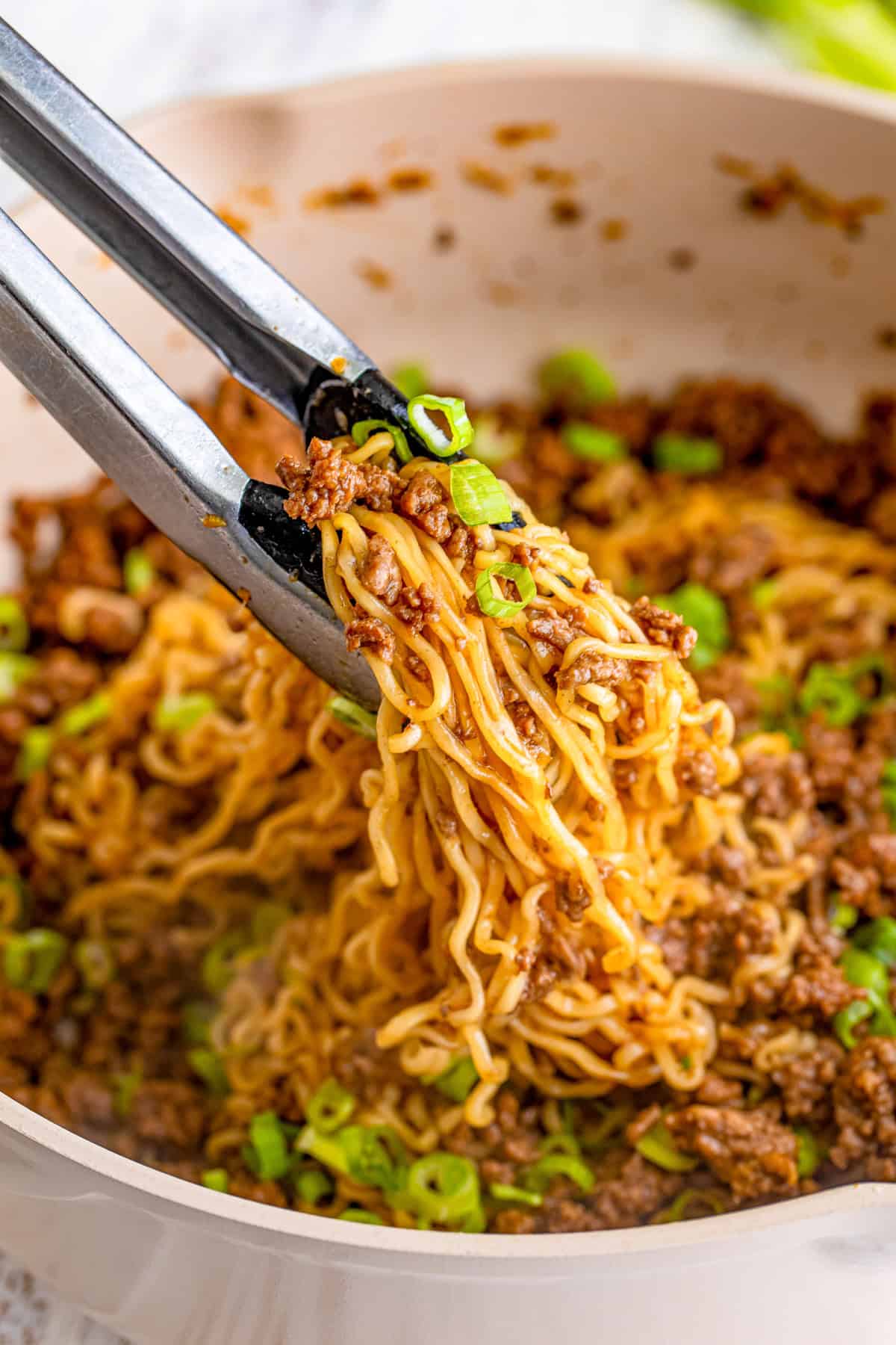 Spatula grabbing some of the ramen out of the pan.