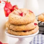Square image of stacked cookies on white pedestal.