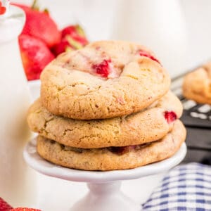Square image of stacked cookies on white pedestal.