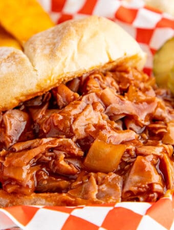 Close up square image of sandwich in a serving container.