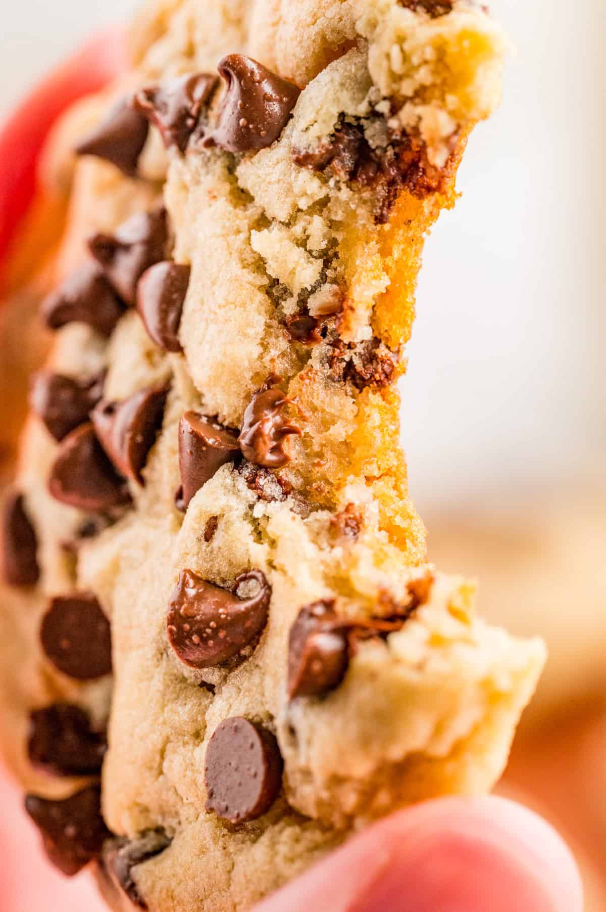 Close up of one cookie with a bite taken out of it.