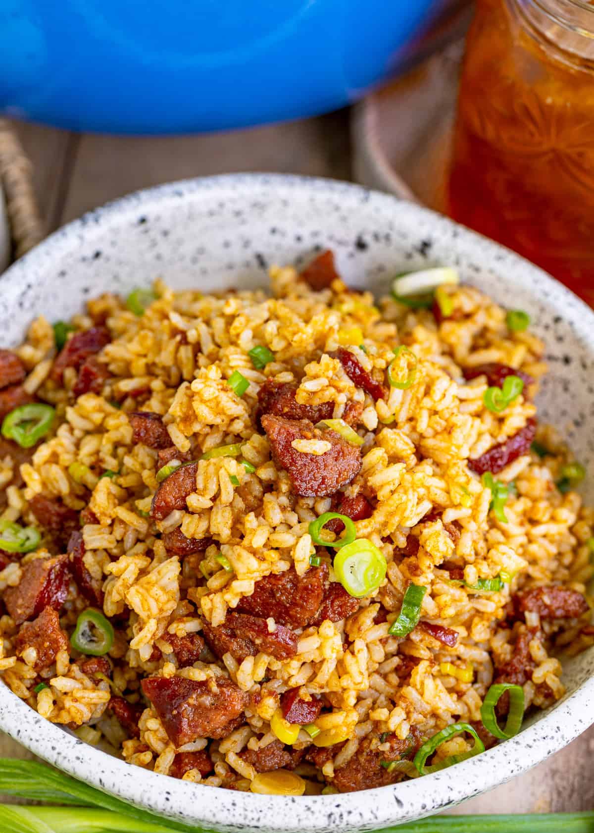 Overhead of rice in bowl with sausage, onion and rice.