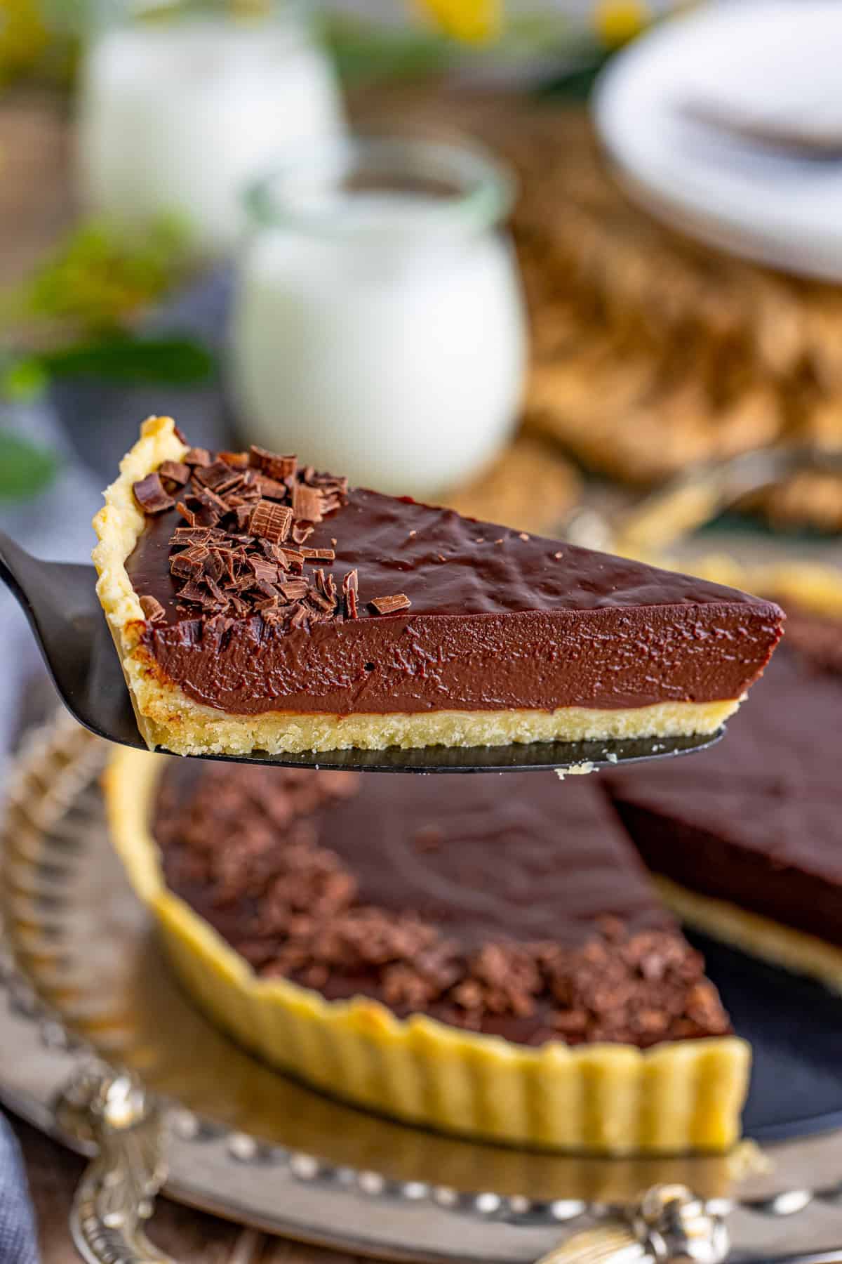 Pie server holding up one slice of the tart.