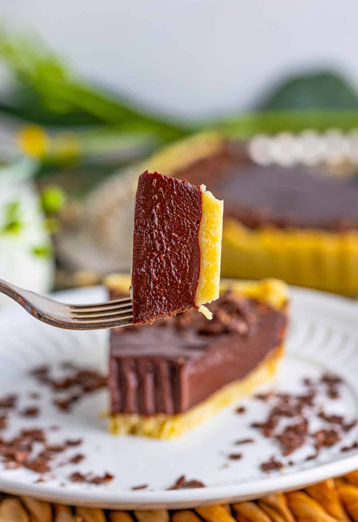 Fork holding up a bite taken out of the tart.