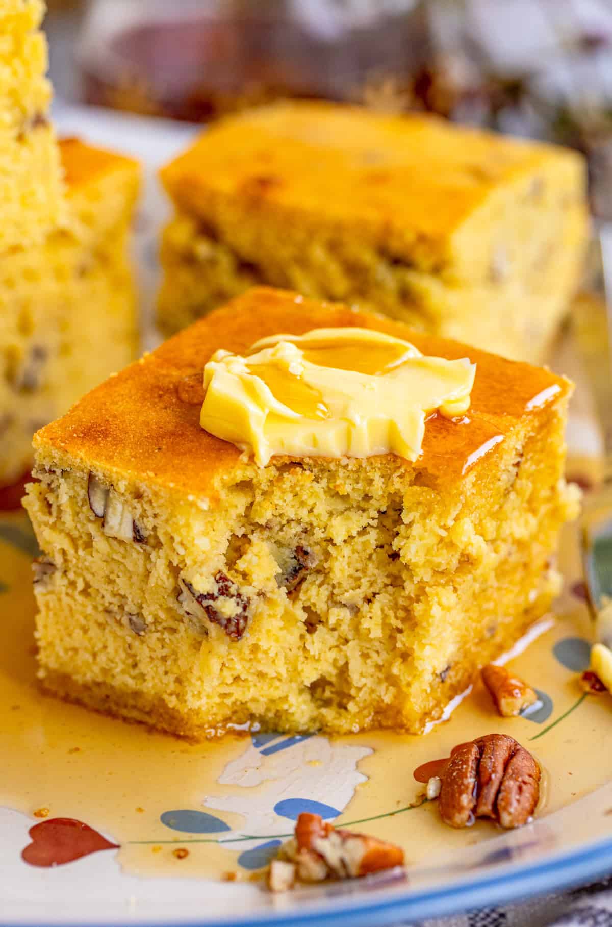 Slice of cornbread with toppings and bite taken out of it