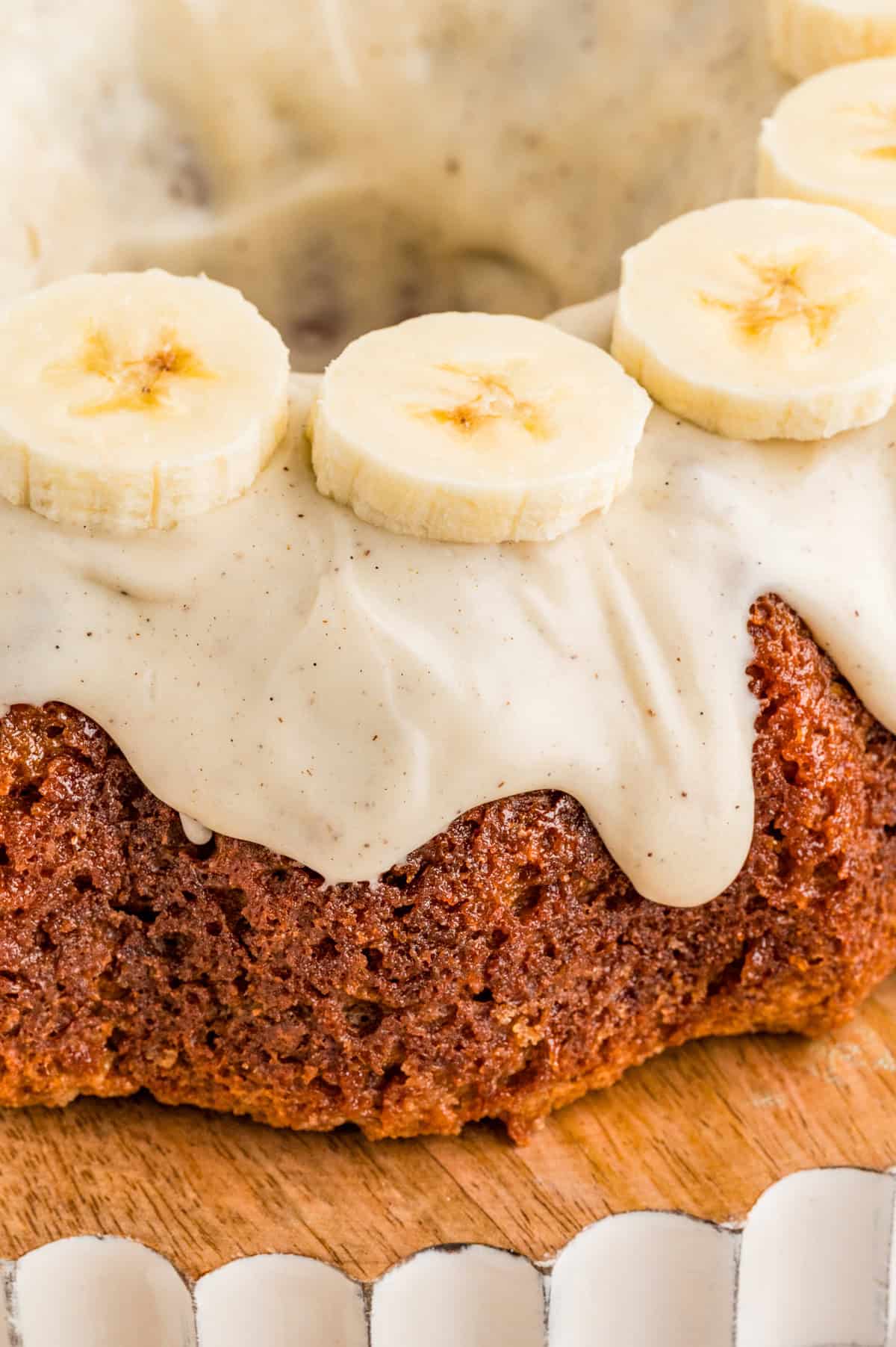 Close up of finished cake showing the glaze and banana topping.