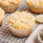 Close up square image of muffins on wire rack showing the topping.