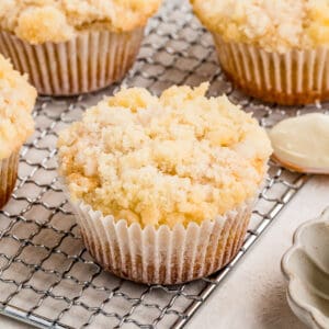 Close up square image of muffins on wire rack showing the topping.