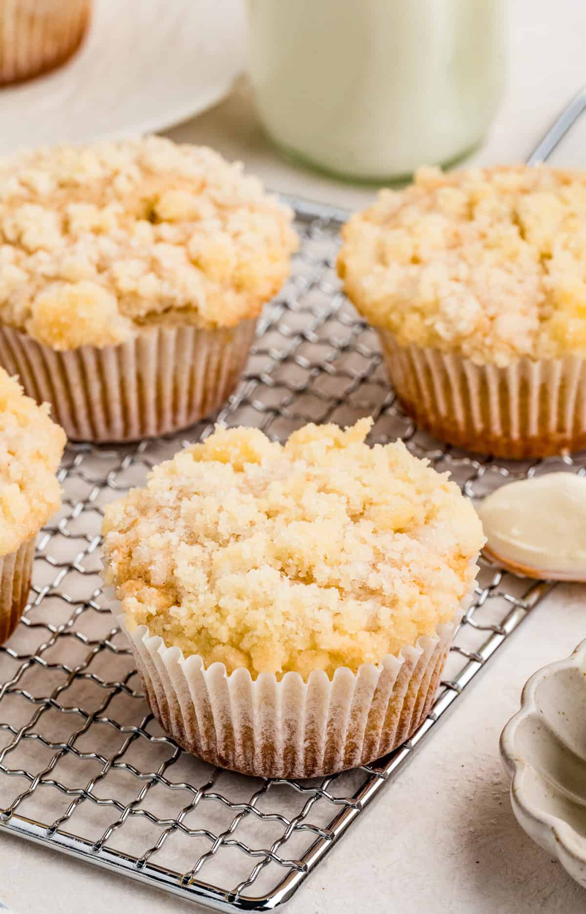 Finished Cream Cheese Muffins on wire rack showing the topping.