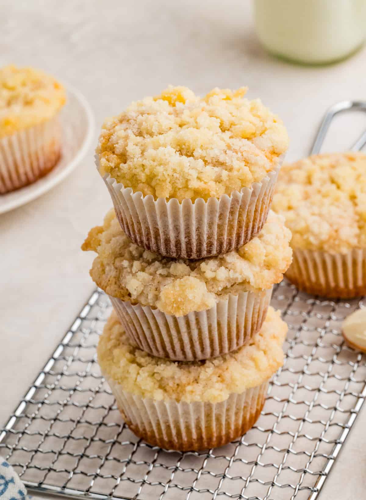 Three stacked muffins on wire rack.