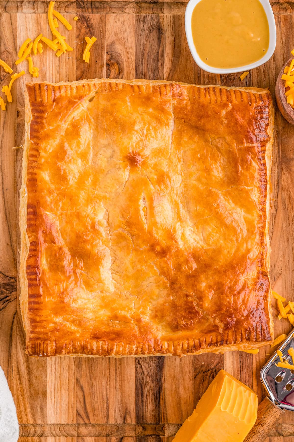 Overhead of finished Ham and Cheese Puff Pastry on cutting board.