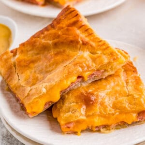 Close up of two stacked pastries on white plate.