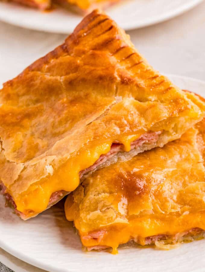 Close up of two stacked pastries on white plate.