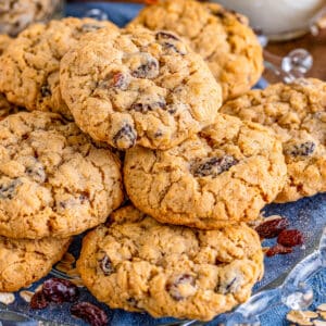 Close up square image of cookies stacked on blue linen.
