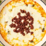 Close up square overhead photo of queso topped with chorizo.