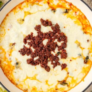 Close up square overhead photo of queso topped with chorizo.