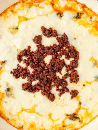 Close up square overhead photo of queso topped with chorizo.
